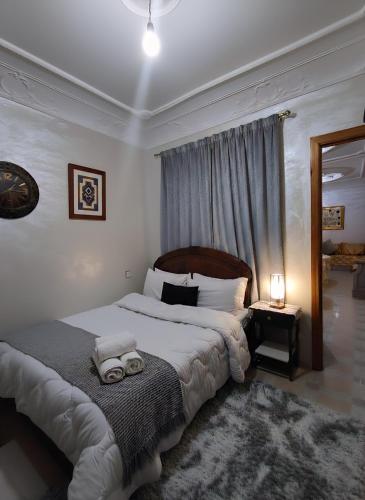 a bedroom with a large bed with towels on it at Martil Beach Apartment in Martil