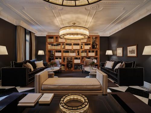 a living room with a couch and a chandelier at Hotel Único Madrid, Small Luxury Hotels in Madrid