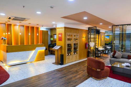 a lobby of a hotel with a couch and a table at İstport Hotels in Arnavutköy