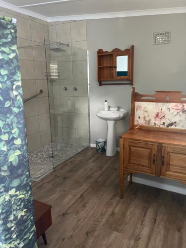 a bathroom with a sink and a shower and a sink at Grace from Above in Malmesbury