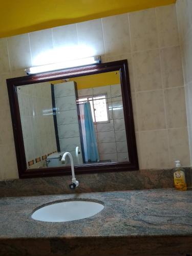 a bathroom with a sink and a mirror at Kamsons in Mombasa