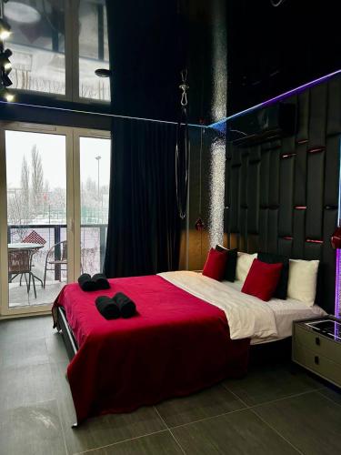 a bedroom with a large bed with red pillows at Angels Spa & Massage by Secret Apartaments in Gdańsk