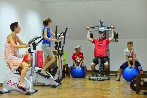 a group of people riding on exercise bikes in a gym at Happy Camp mobile homes in Camping Amadria Park Camping Trogir in Seget Vranjica