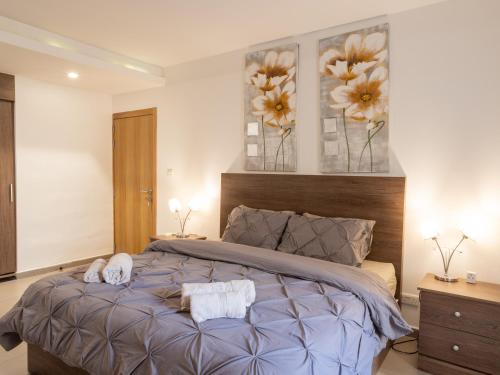 a bedroom with a bed with two towels on it at Birgu Seafront 3 Bedroom Apartment in Vittoriosa