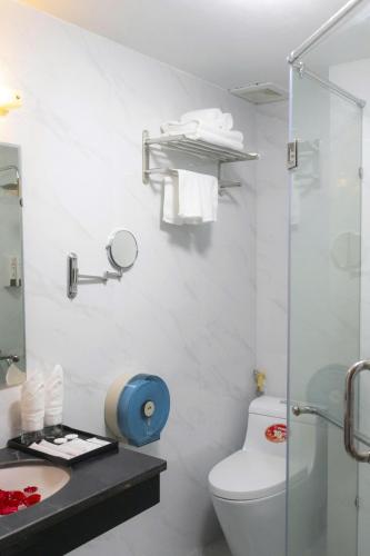 a bathroom with a toilet and a sink and a shower at Capital CauGiay Hotel in Hanoi