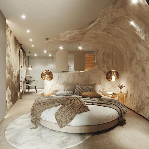 a bedroom with a large bed in a stone wall at My Mountain Moments - Adults Only 12 plus in Selva dei Molini