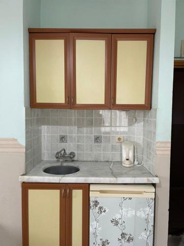 a kitchen counter top with a sink and cabinets at Best Life Apart Hotel in Alanya