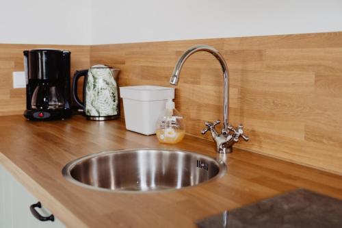 a kitchen counter with a stainless steel sink at Huize Henk in Emst