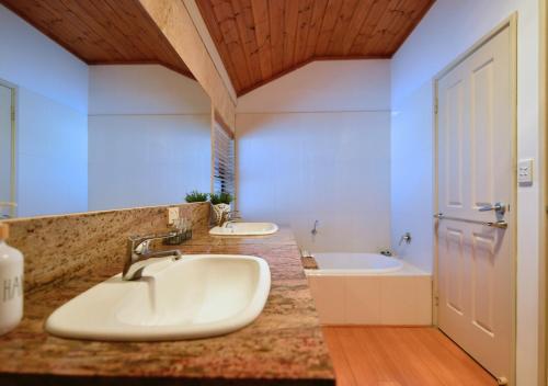 a bathroom with a sink and a tub at Radford Retreat in Safety Bay