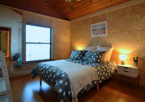 a bedroom with a bed and a window in it at Radford Retreat in Safety Bay