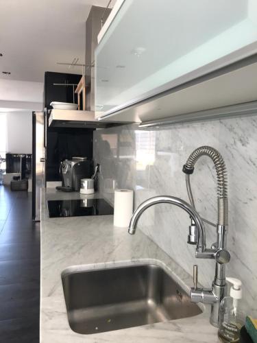 a kitchen with a stainless steel sink and a counter top at C'est la vie! in L'Escala
