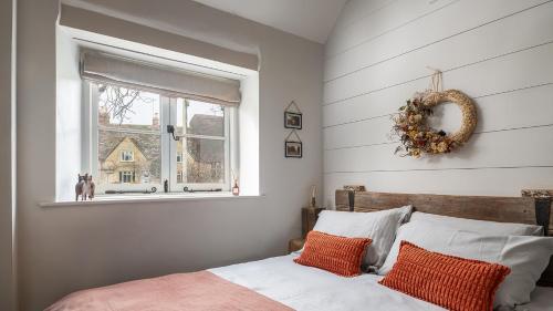 a bedroom with a bed and a window with a wreath at Filly Island in South Cerney