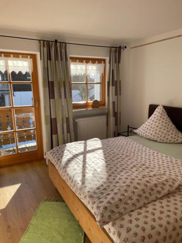 a bedroom with a bed and a window at Apartment Rothenlehen in Bischofswiesen