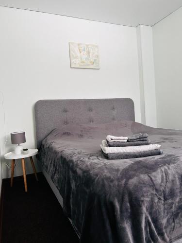 a bedroom with a bed with towels on it at Книжка in Vinnytsya