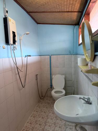 a bathroom with a toilet and a sink at TEAK HOUSE In TOWN in Mae Hong Son
