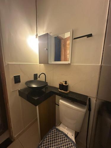 a small bathroom with a sink and a toilet at Flat Dourado a 5minutos do Parnaíba Shopping in Parnaíba