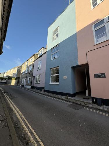 a row of buildings on the side of a street at Teal House in Lyme Regis