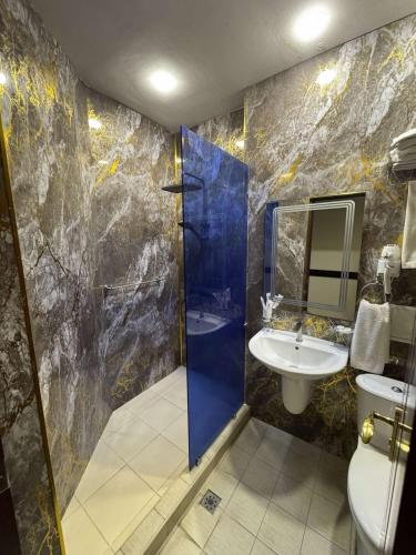 a bathroom with a shower and a toilet and a sink at Canyon Hills Hotel in Yerevan