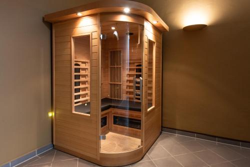 a wine cellar with a wooden cabinet in a room at Fletcher Hotel-Restaurant Arnsberg-Sauerland in Arnsberg