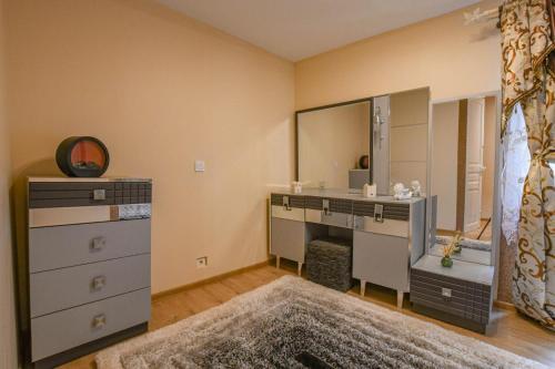 a bathroom with a vanity and a sink and a mirror at La lukas in Mussy-sur-Seine