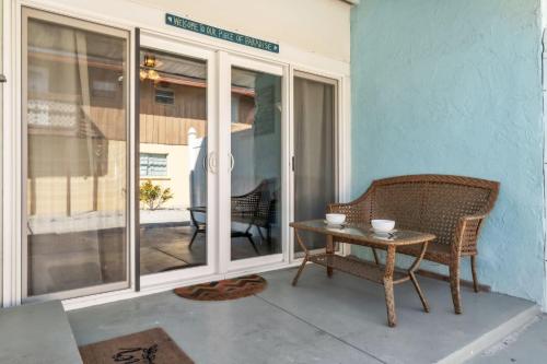 a patio with a table and a chair on a porch at Island Gem A home in Anna Maria