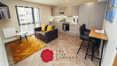 a living room with a couch and a table at The Stay Company, Whitefriars House in Nottingham