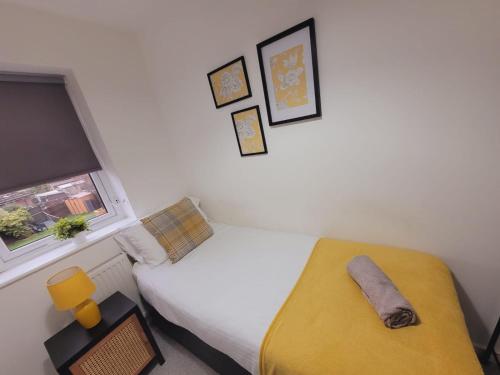 a small bedroom with a bed and a window at Ideal Lodgings in Radcliffe in Radcliffe