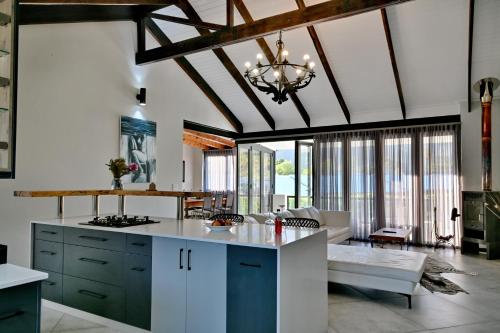 a kitchen with a stove top island in a room at Mimosa Lodge in Montagu