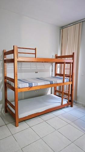 two bunk beds sitting in a room with at Casa Itanhaém Praia Cibratel in Itanhaém
