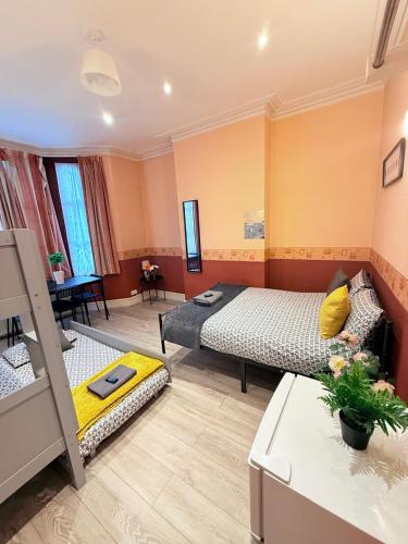 a room with two beds and a living room at 25 Minutes to Central London Rooms 35 in London