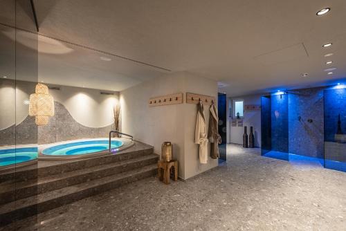 a bathroom with a tub and a walk in shower at Residence Angelika in Corvara in Badia