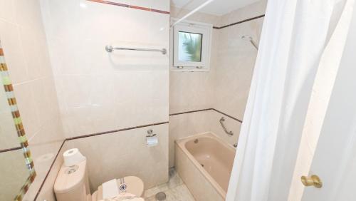 a bathroom with a toilet and a bath tub at Casinomar Apartments Pool, Garden & Private Terrace in Benalmádena