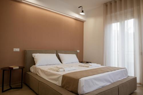 a bedroom with a large bed with two towels on it at VenereCiprea in Castelbuono