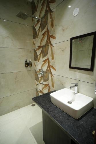 a bathroom with a sink and a shower at The Leaf Farm in Ludhiana