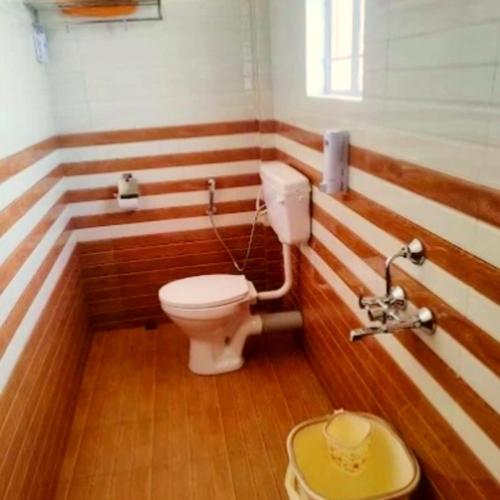 a bathroom with a toilet and a sink at Za Homestay in Cherrapunji