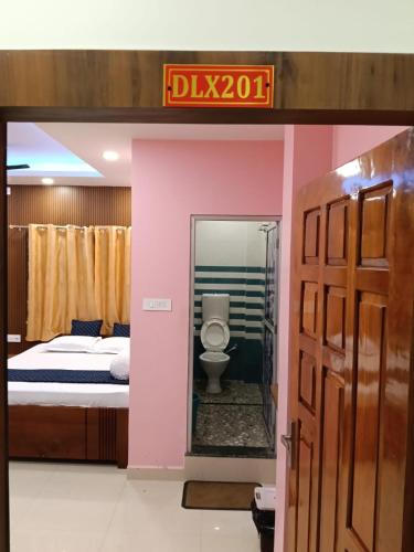 a hotel room with a bed and a toilet at Roy Guest House in Kānki