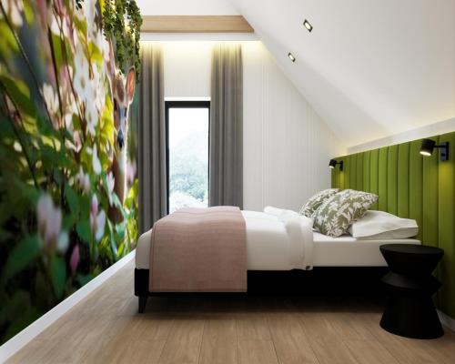 a bedroom with a bed and a painting on the wall at Prime - Event & Relax Resort in Jaszczurowa