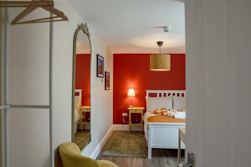 a bedroom with red walls and a bed at 32 Bondgate Without in Alnwick