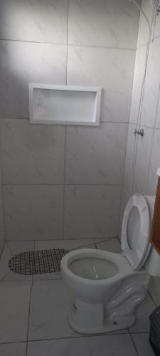 a bathroom with a toilet with the lid up at Pousada Germânia em Paraíso do Sul RS in Paraíso do Sul
