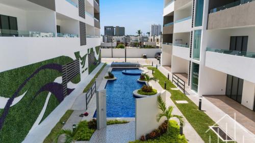 an aerial view of an apartment building with a swimming pool at New-Promo-2 Queen Beds-Near Beach-Poolside-Sleep 6 in Mazatlán