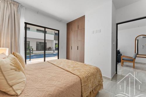 a bedroom with a bed and a large window at New-Promo-2 Queen Beds-Near Beach-Poolside-Sleep 6 in Mazatlán