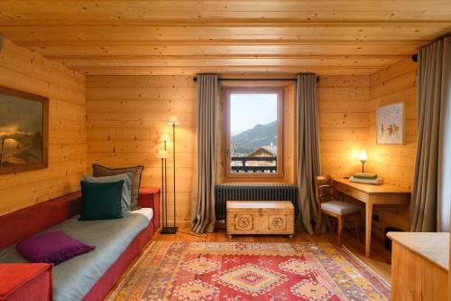 a bedroom in a log cabin with a bed and a window at Chalet François in Champéry