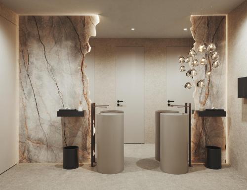 a bathroom with three urinals and a marble wall at My Mountain Moments - Adults Only 12 plus in Selva dei Molini