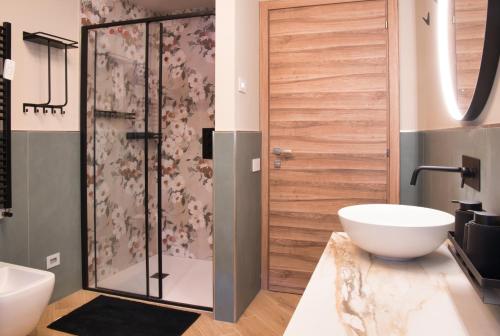 a bathroom with a shower and a white sink at El Surcinel – Alpine Design Home in Ballabio
