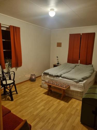 a bedroom with a large bed and a wooden floor at Idyllic house on a farm in Steinkjer