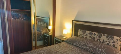 a bedroom with a bed and a large mirror at Mar y Montaña in Laredo