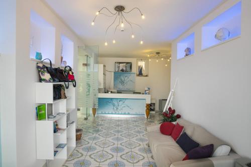 a living room with a couch and a table at Gigli Hotel Salento in Marina di Pescoluse