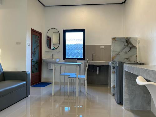 a bathroom with a sink and a table and a mirror at Lanta Beautiful beach house 1 in Phra Ae beach