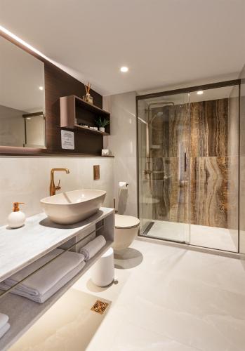 a bathroom with a sink and a toilet and a shower at Jurmala Spa Hotel in Jūrmala