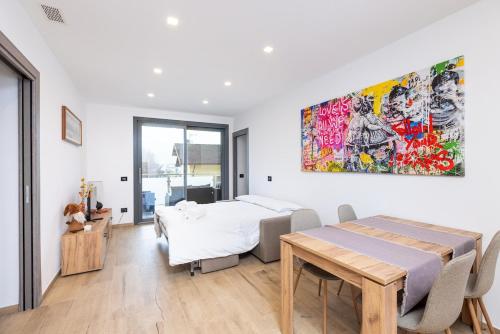 a bedroom with two beds and a table in it at La Strencia in Villa di Tirano